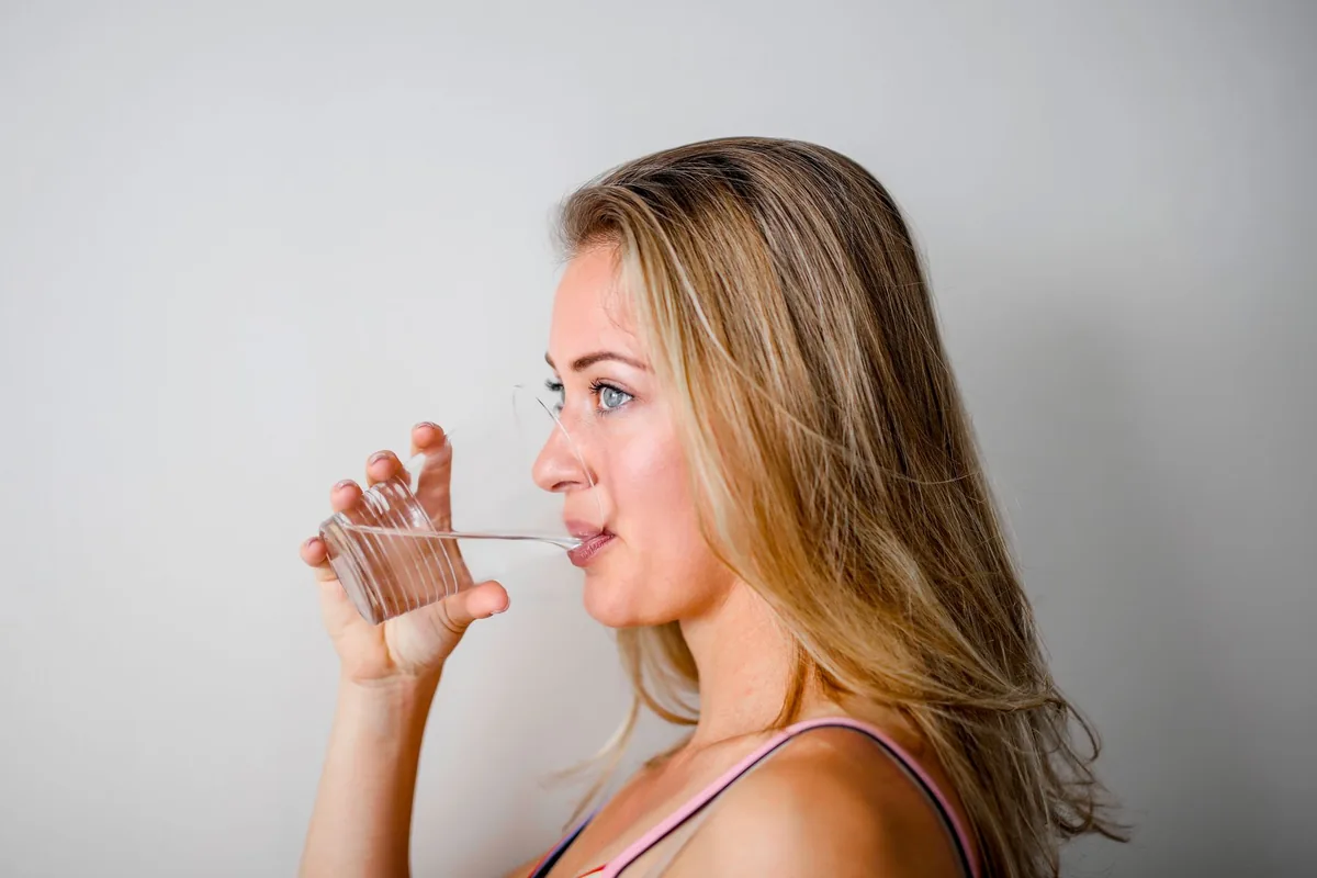 A woman drinking a glass of water